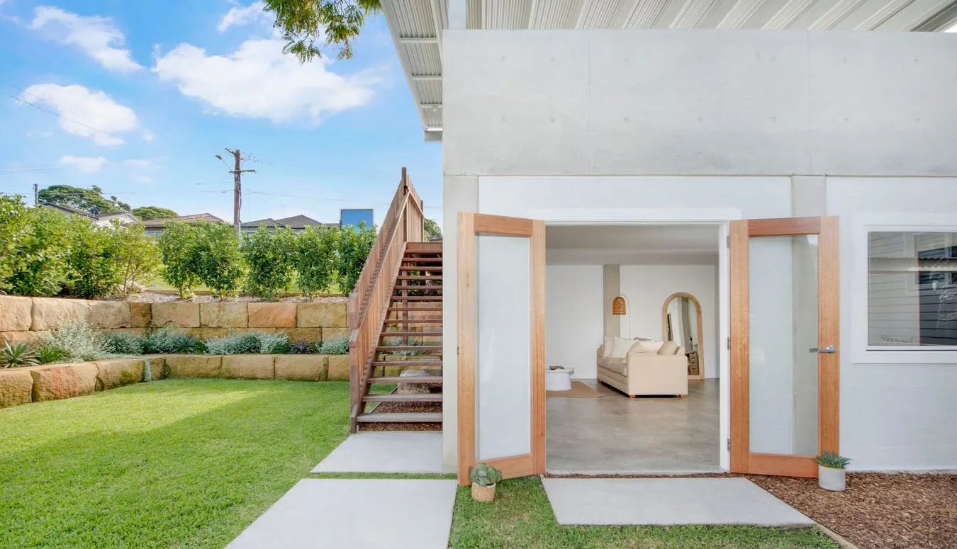Home with tiered retaining walls levelling a sloped backyard