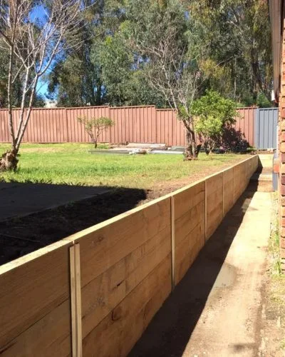 Timber sleeper retaining wall along a narrow side garden