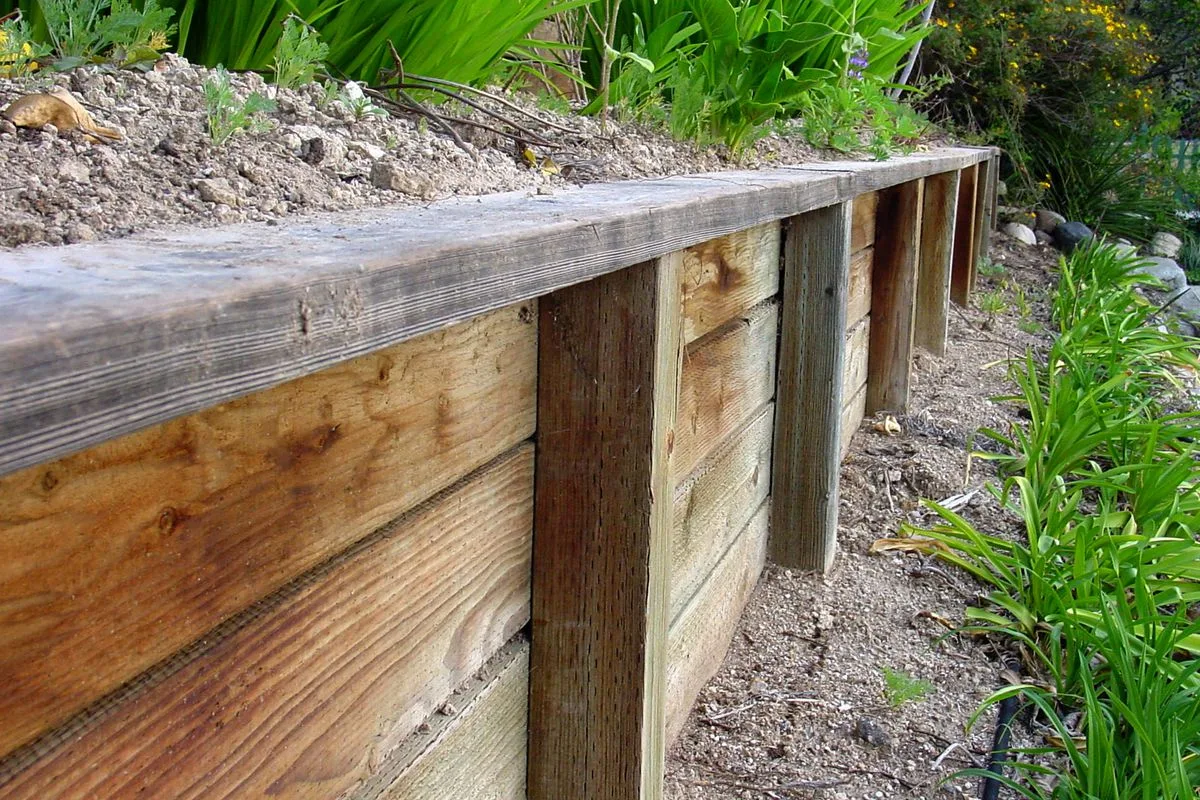 Close-up of a timber sleeper retaining wall with steel posts