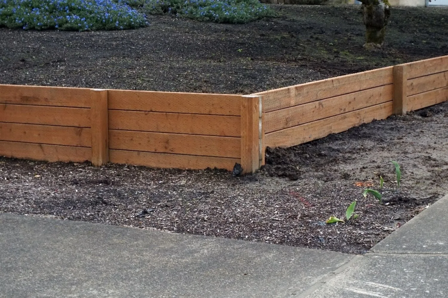 Treated pine sleeper retaining wall around a garden bed